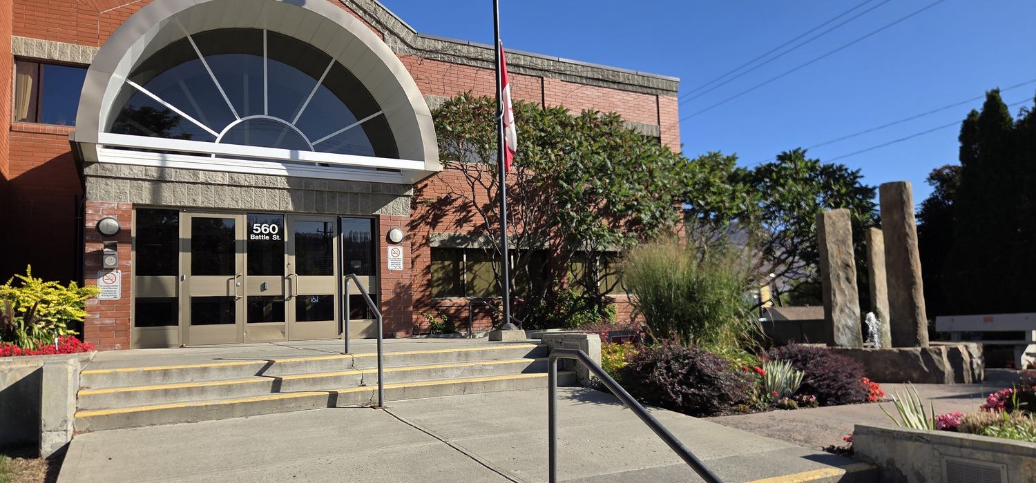 The main entrance of the Kamloops RCMP detachment at 560 Battle Street: red brick with a large arched window over the doors.