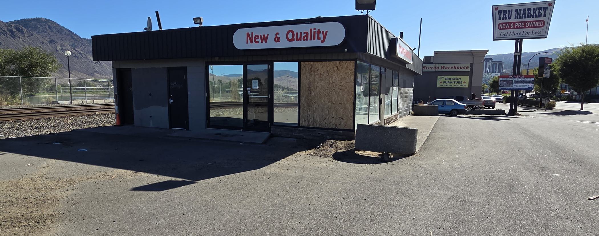 The former TRU Market Auto Sales premises on West Victoria Street: an empty lot with one window boarded over.