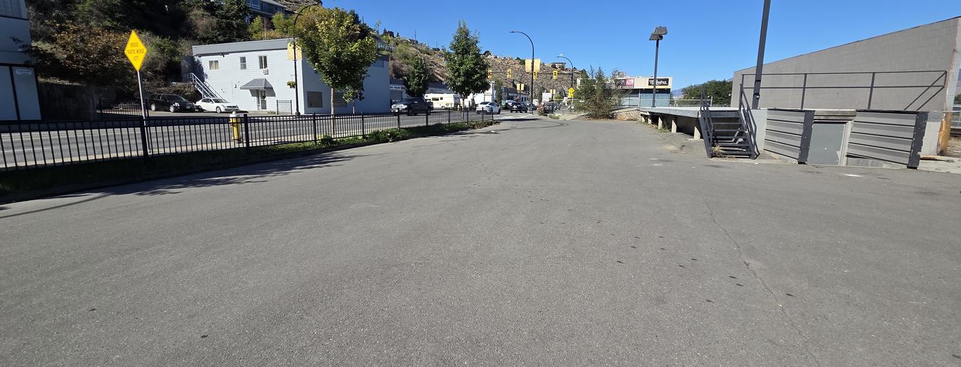 A wide, empty stretch of pavement beside West Victoria Street.